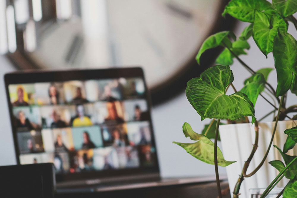 open laptop computer screen with faces for online meeting